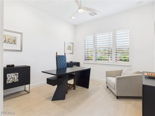 a view of a workspace with furniture and a window