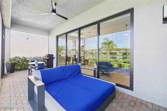 a living room with couch and a floor to ceiling window