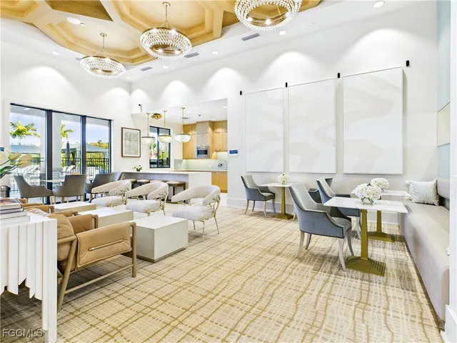 a living room with lots of white furniture and a table