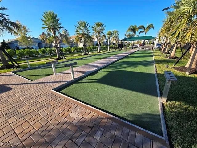 a view of a patio with couches chairs and a wooden floor