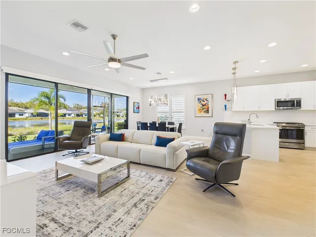 a living room with furniture and a large window with outer view