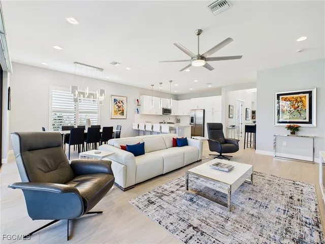 a living room with furniture a rug and a chandelier