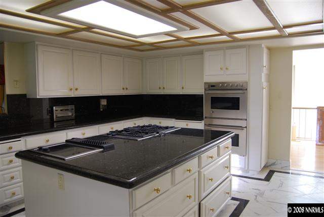 2570 Spinnaker Drive Reno, NV 89519 - Photo 3 of 9 a kitchen with stainless steel appliances granite countertop a stove a sink and a microwave