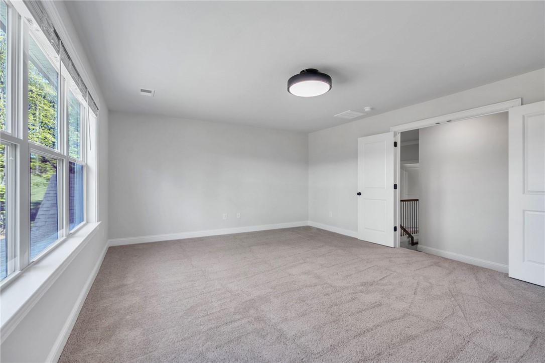 226 Holly Br Road Piedmont, SC 29673 - Photo 27 of 44 The carpeted floor in this generously proportioned room invites relaxation, with natural light pouring in from oversized windows.