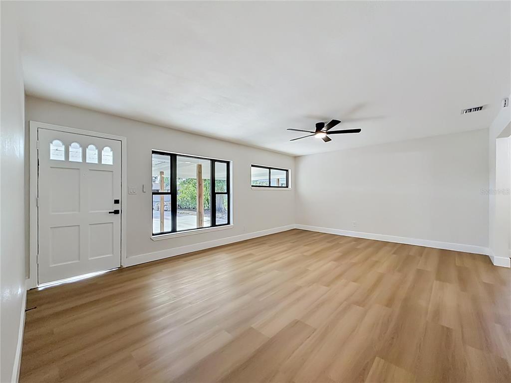 2105 Shaffer Place Orlando, FL 32806 - Photo 16 of 68 a view of empty room with wooden floor and fan