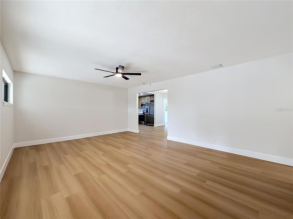 2105 Shaffer Place Orlando, FL 32806 - Photo 17 of 68 a view of an empty room with wooden floor