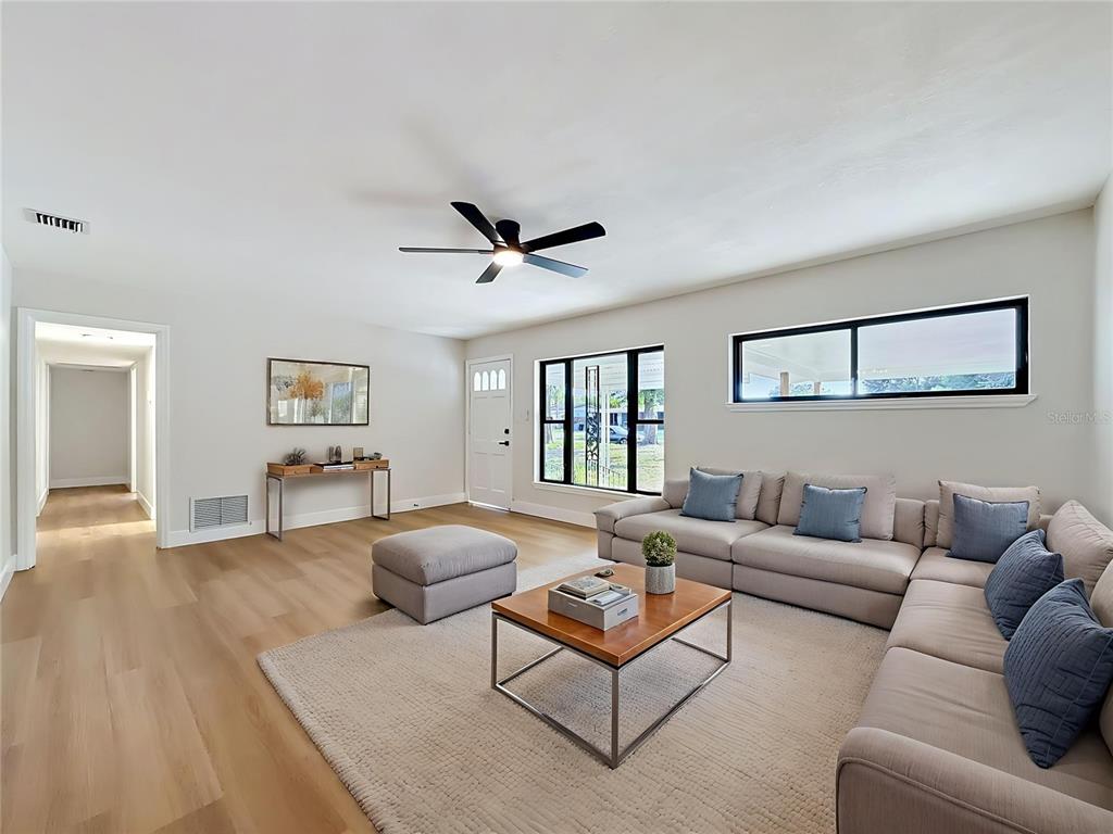 2105 Shaffer Place Orlando, FL 32806 - Photo 18 of 68 a living room with furniture a ceiling fan a rug and a window