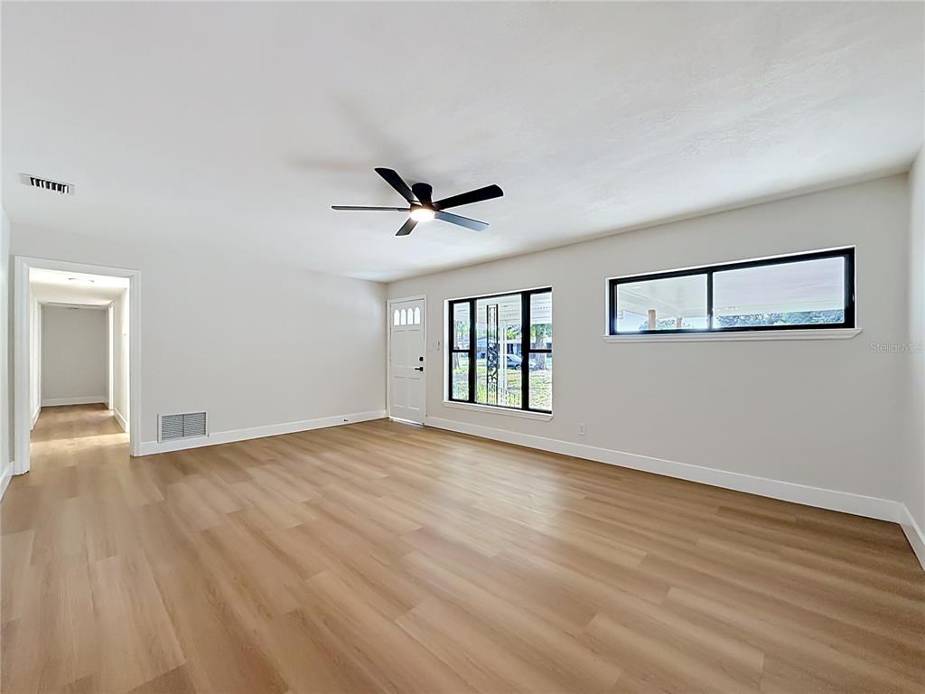 2105 Shaffer Place Orlando, FL 32806 - Photo 20 of 68 a view of empty room with wooden floor and fan