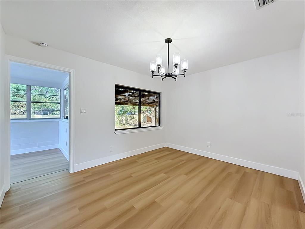 2105 Shaffer Place Orlando, FL 32806 - Photo 21 of 68 wooden floor in an empty room with a window