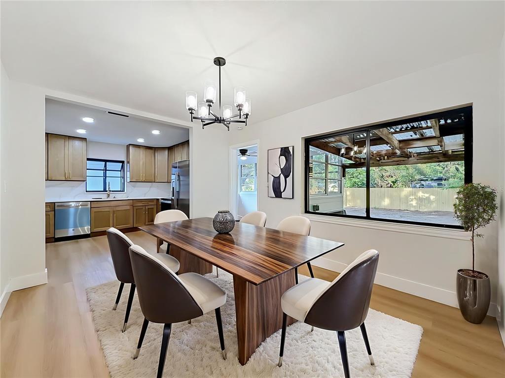 2105 Shaffer Place Orlando, FL 32806 - Photo 22 of 68 a view of a dining room with furniture window and wooden floor