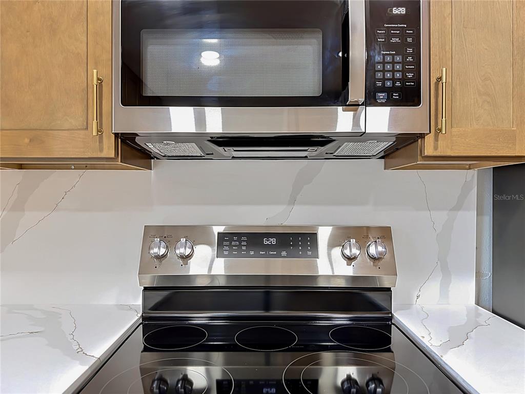 2105 Shaffer Place Orlando, FL 32806 - Photo 31 of 68 a stove top oven sitting inside of a kitchen