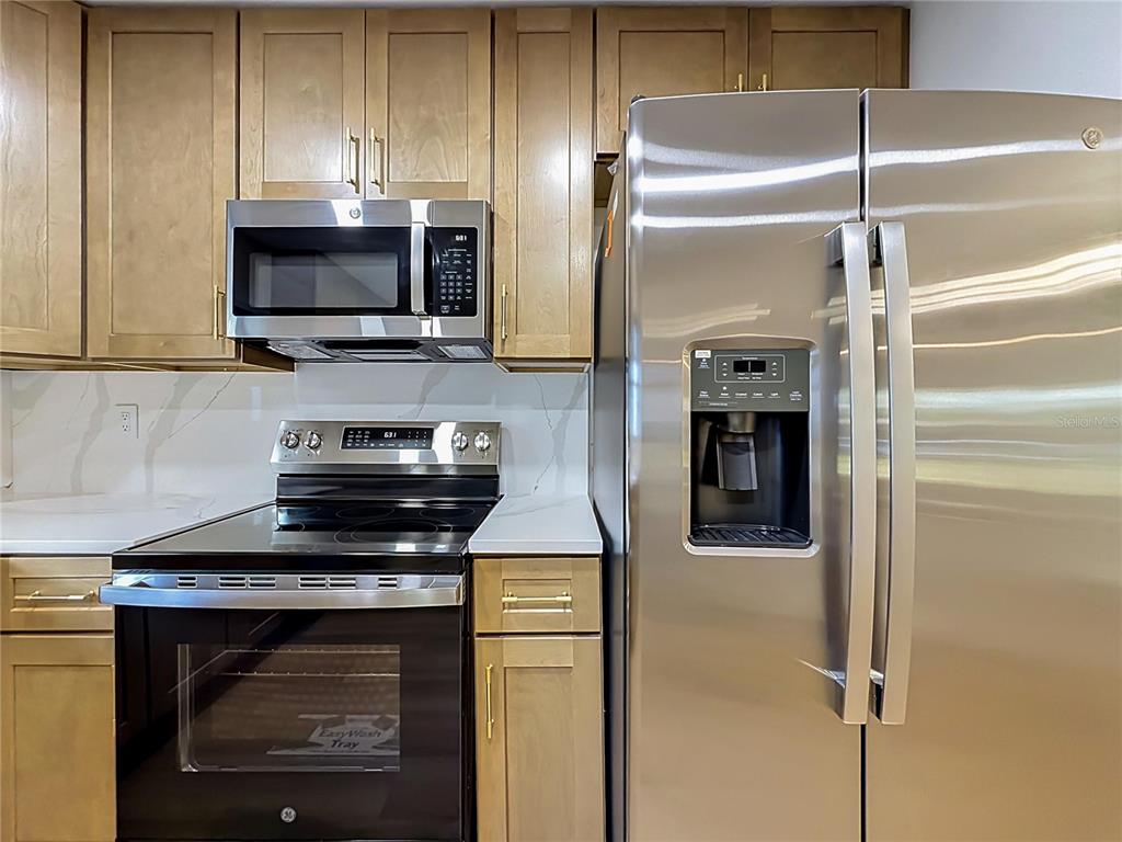 2105 Shaffer Place Orlando, FL 32806 - Photo 37 of 68 a kitchen with a stove and a microwave