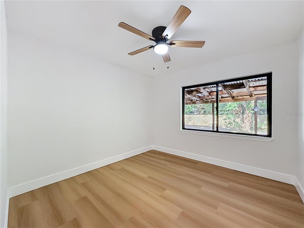 2105 Shaffer Place Orlando, FL 32806 - Photo 38 of 68 an empty room with window and ceiling fan