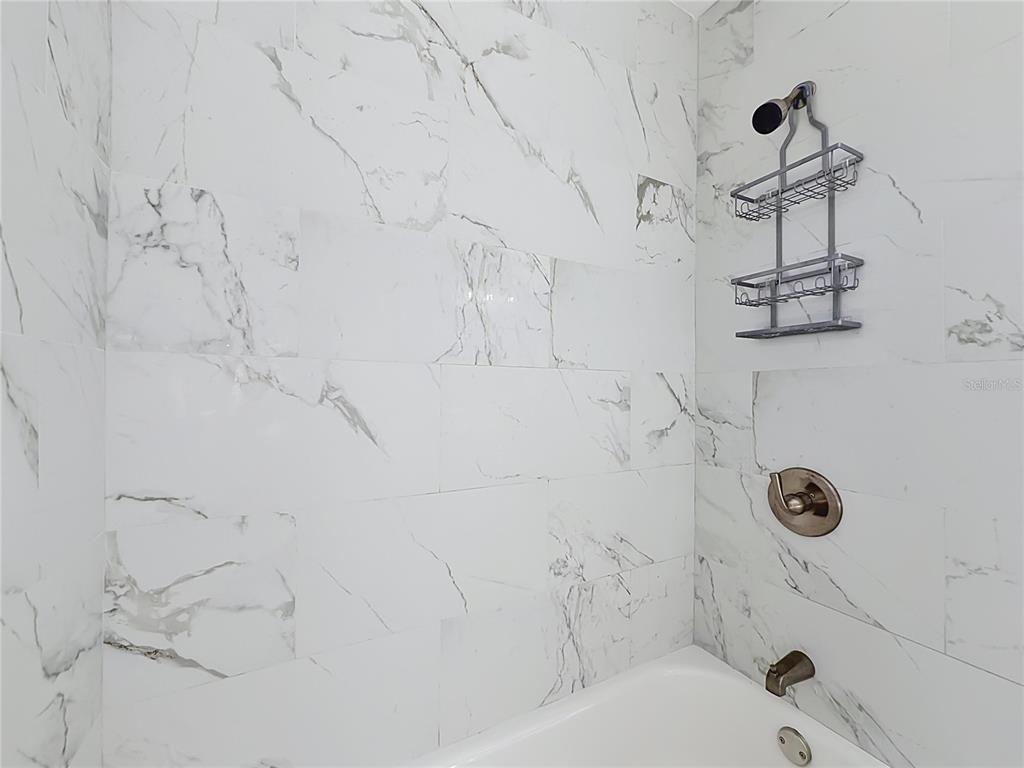 2105 Shaffer Place Orlando, FL 32806 - Photo 43 of 68 a bathroom with white shower