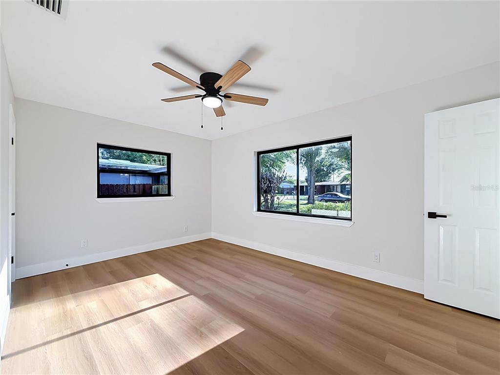 2105 Shaffer Place Orlando, FL 32806 - Photo 48 of 68 a view of a big room with wooden floor and windows