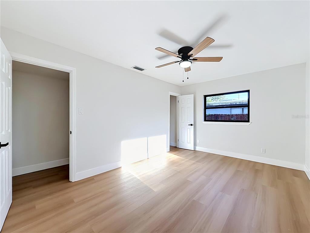 2105 Shaffer Place Orlando, FL 32806 - Photo 52 of 68 a view of a room with wooden floor and a ceiling fan