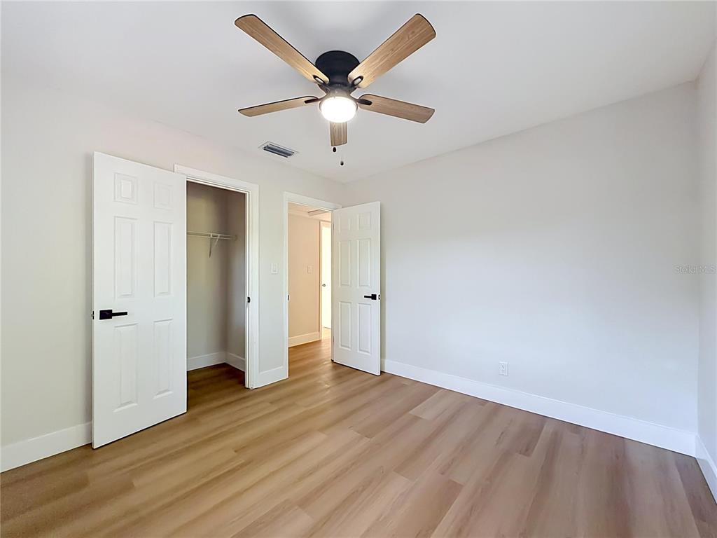 2105 Shaffer Place Orlando, FL 32806 - Photo 57 of 68 an empty room with wooden floor and ceiling fan
