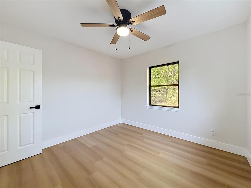 2105 Shaffer Place Orlando, FL 32806 - Photo 58 of 68 an empty room with a window and a ceiling fan
