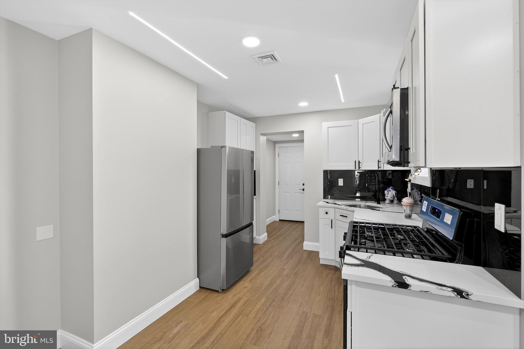 3450 Hurley Street Philadelphia, PA 19134 - Photo 16 of 31 a kitchen with a refrigerator and a stove top oven