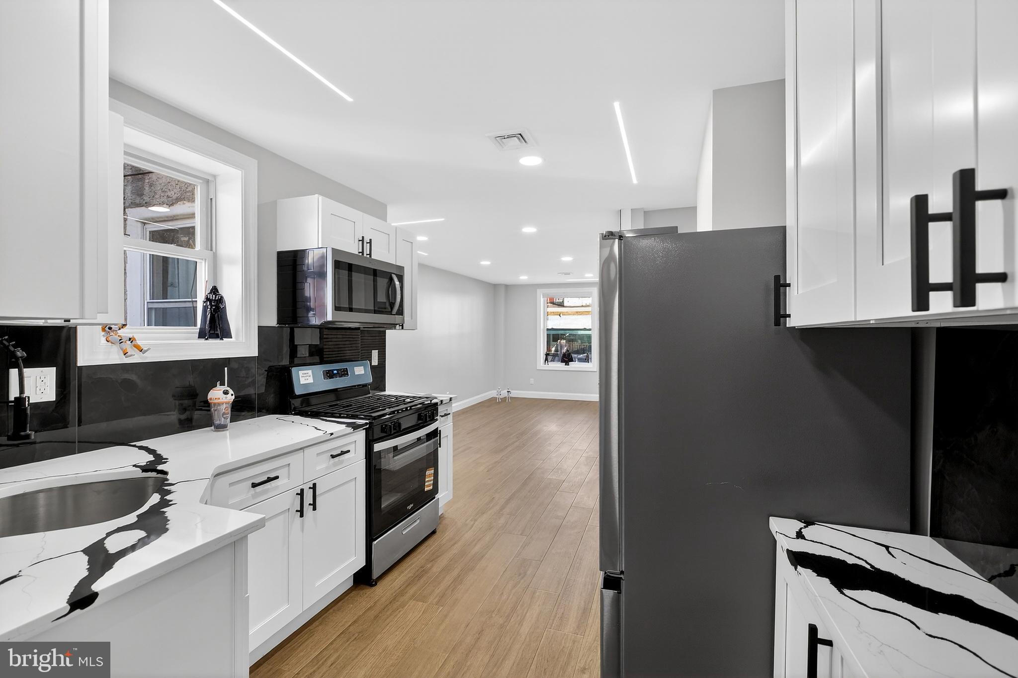 3450 Hurley Street Philadelphia, PA 19134 - Photo 17 of 31 a kitchen with stainless steel appliances a sink stove and refrigerator