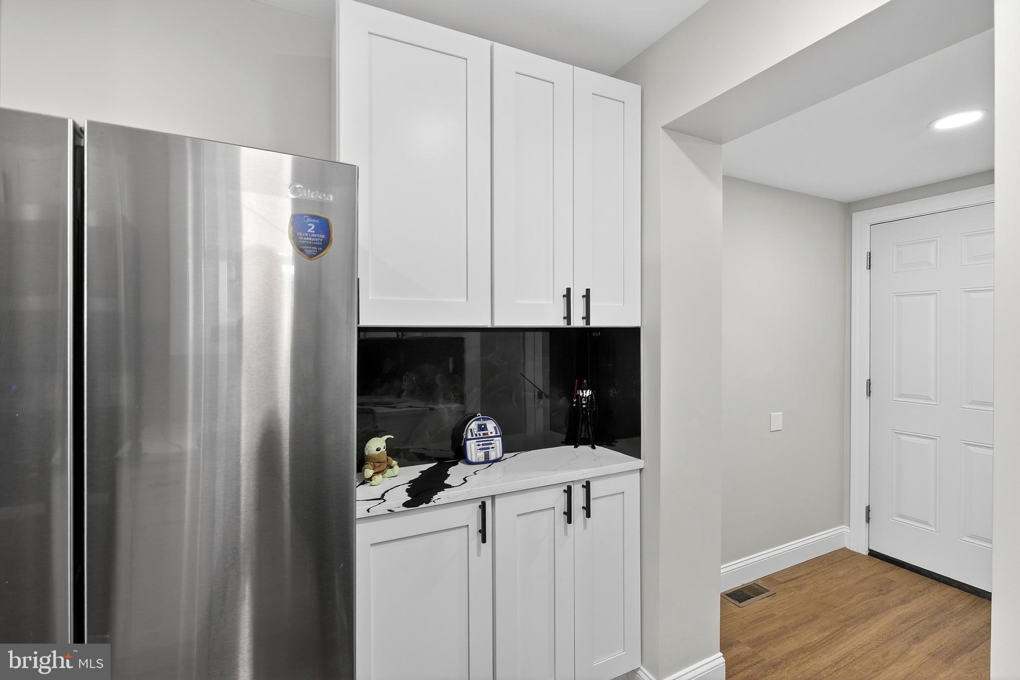 3450 Hurley Street Philadelphia, PA 19134 - Photo 18 of 31 a kitchen with a refrigerator and white cabinets