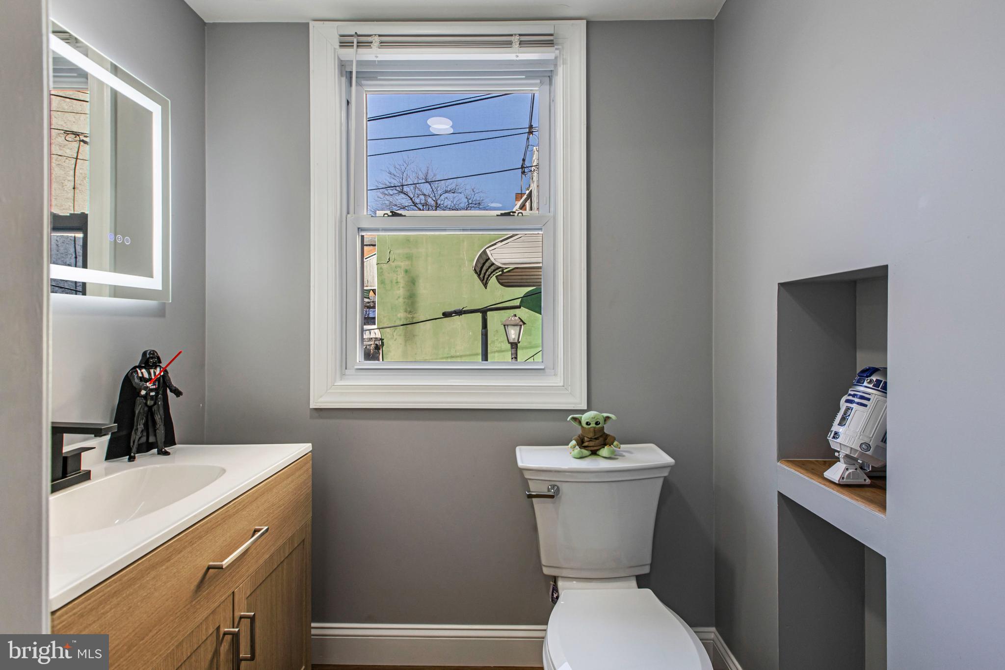 3450 Hurley Street Philadelphia, PA 19134 - Photo 19 of 31 a bathroom with a sink mirror vanity and toilet