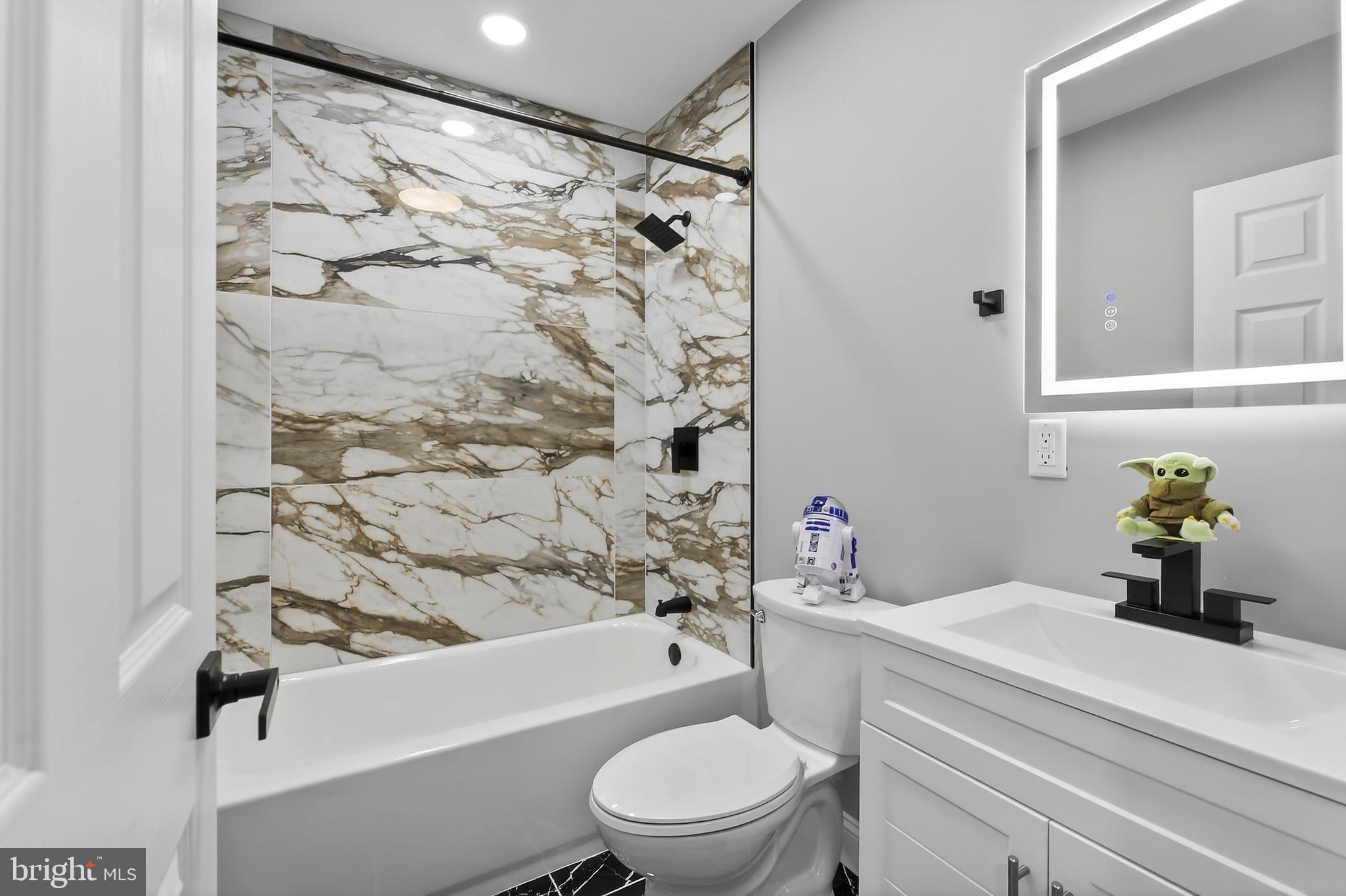 3450 Hurley Street Philadelphia, PA 19134 - Photo 21 of 31 a bathroom with a bathtub shower sink vanity and toilet