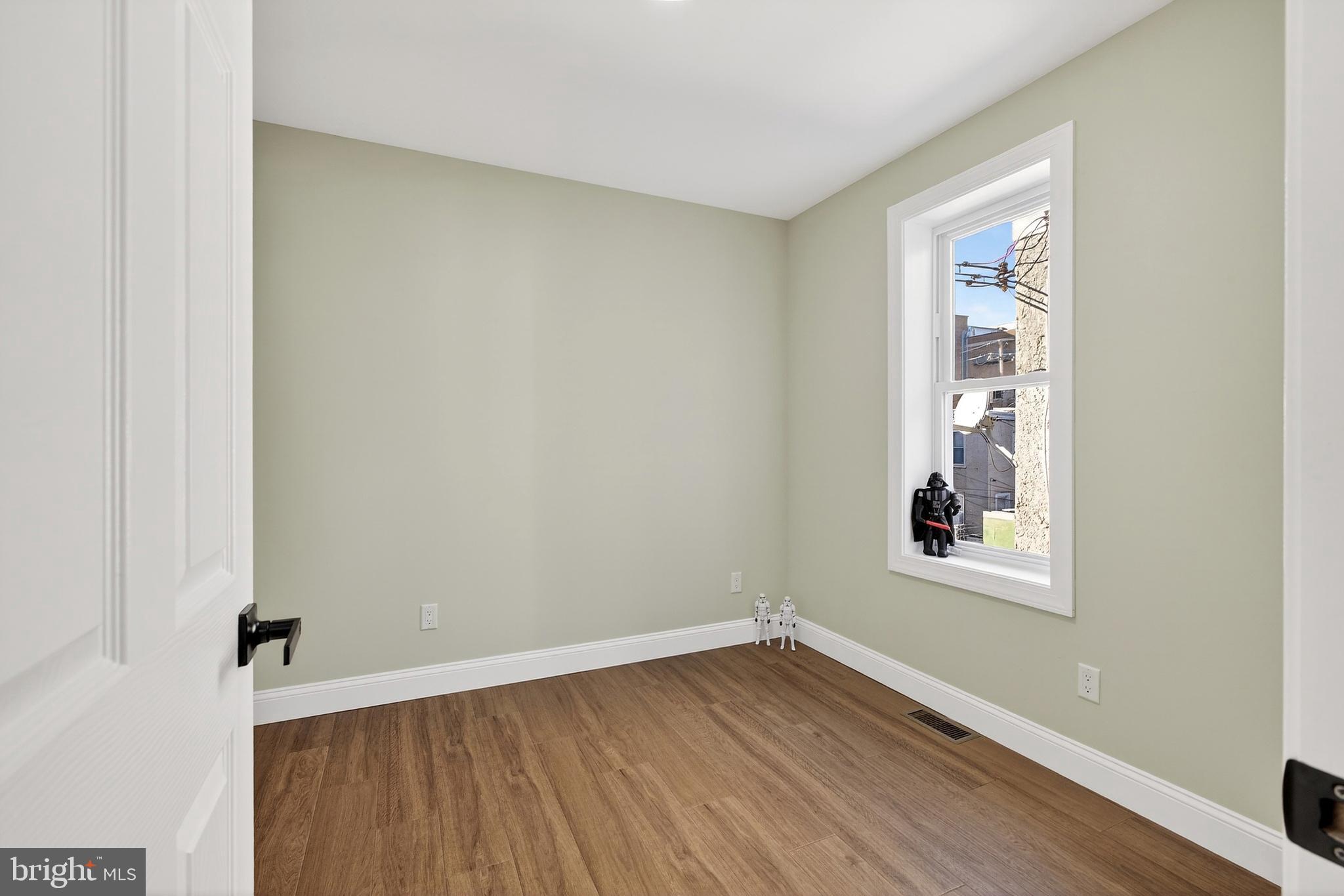3450 Hurley Street Philadelphia, PA 19134 - Photo 25 of 31 an empty room with a window and wooden floor