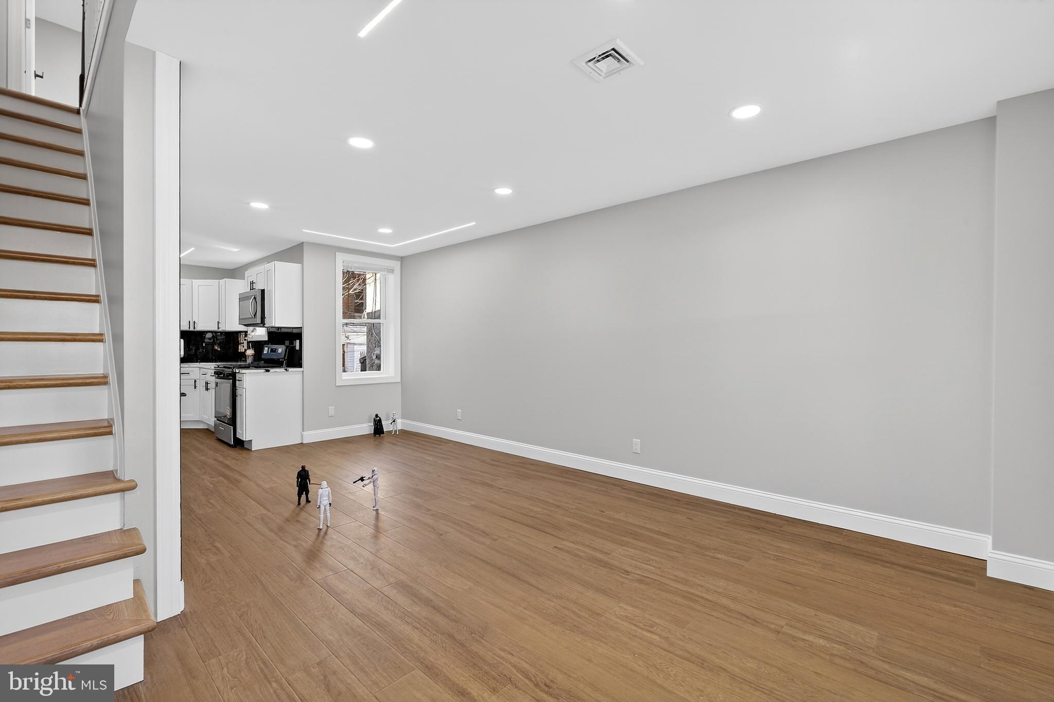 3450 Hurley Street Philadelphia, PA 19134 - Photo 10 of 31 wooden floor in an empty room with a kitchen