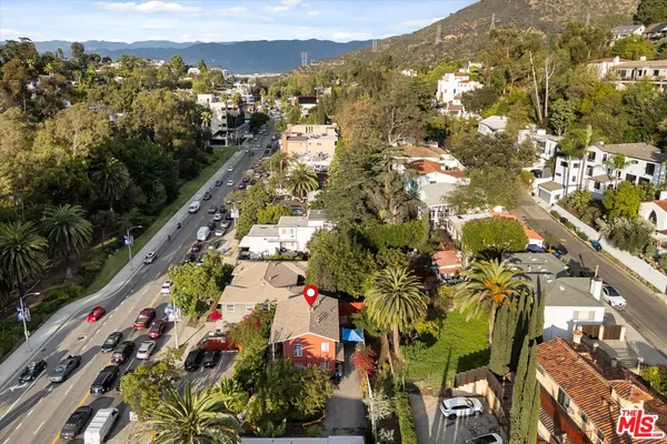 an aerial view of a house with garden space and street view