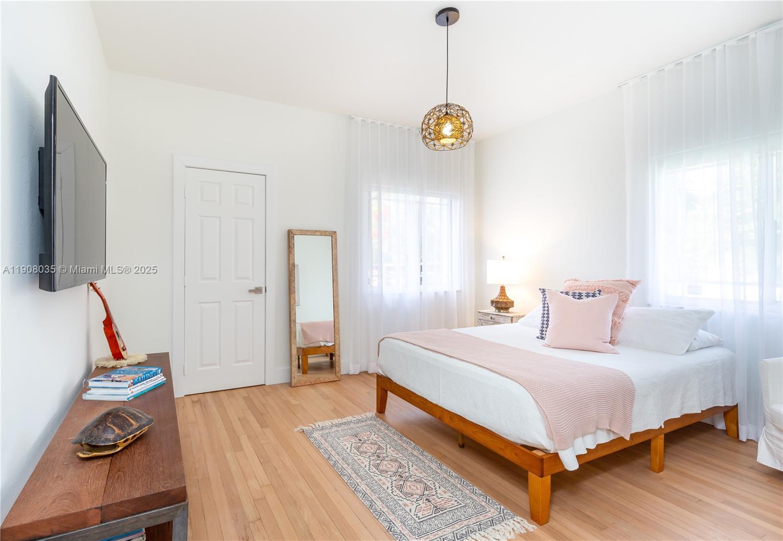 501 Southwest 19th Road Miami, FL 33129 - Photo 17 of 59 a bedroom with a bed and wooden floor