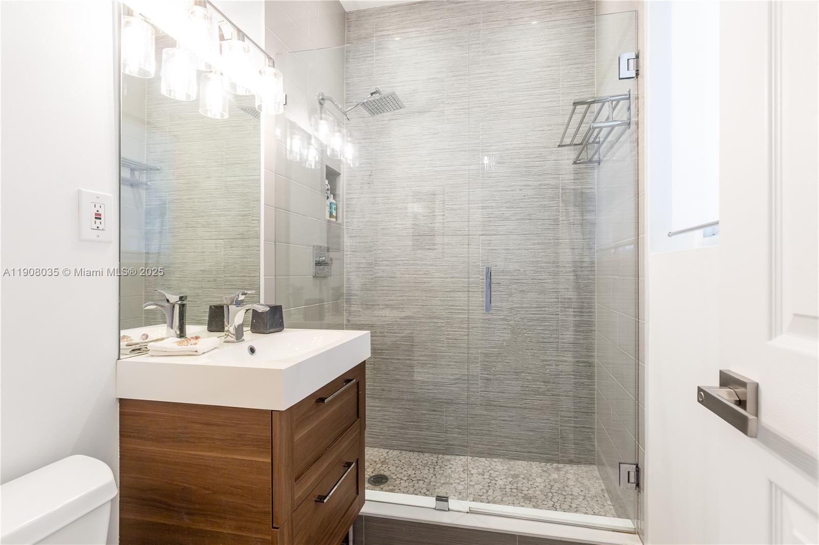 501 Southwest 19th Road Miami, FL 33129 - Photo 32 of 59 a bathroom with a sink a toilet and shower