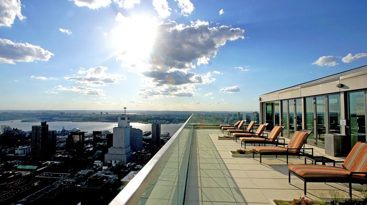 322 West 57th Street, Unit 48F Manhattan, NY 10019 - Photo 9 of 12 a roof deck with outdoor seating and city view