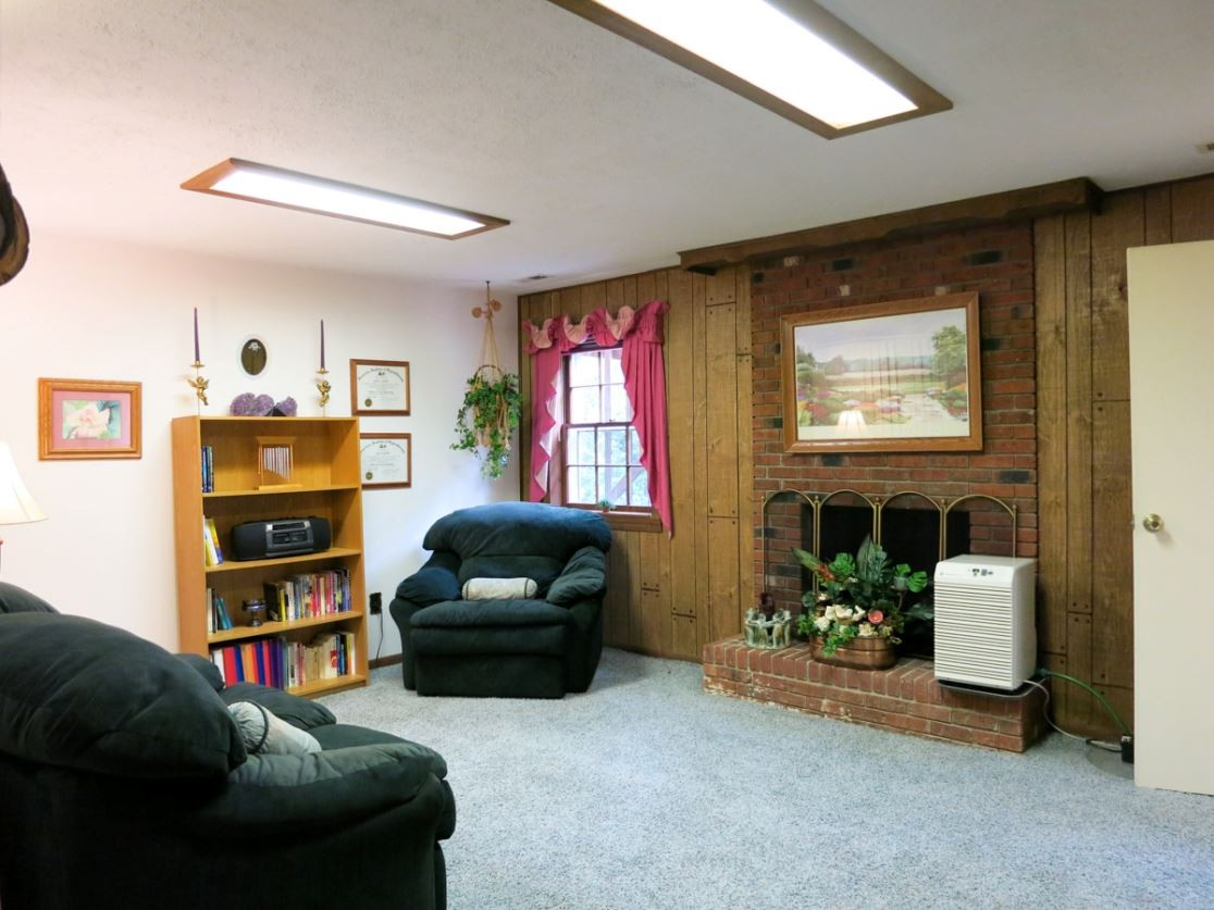 613 Compton Road Raleigh, NC 27609 - Photo 16 of 25 On the Lower Level is the huge Bonus Rm w/brick raised-hearth wood burning FP, carpet & wall of deep closets. Bonus Room