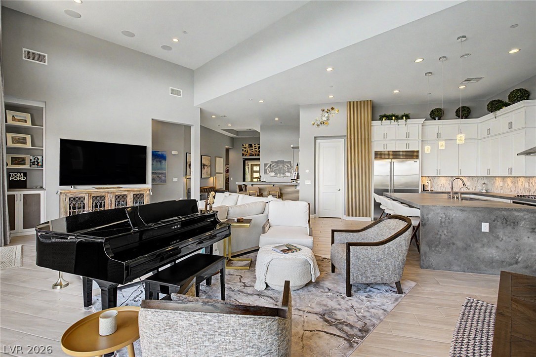 6014 Willow Ridge Court Las Vegas, NV 89135 - Photo 23 of 99 This expansive great room seamlessly connects living and kitchen spaces, ideal for modern entertaining.