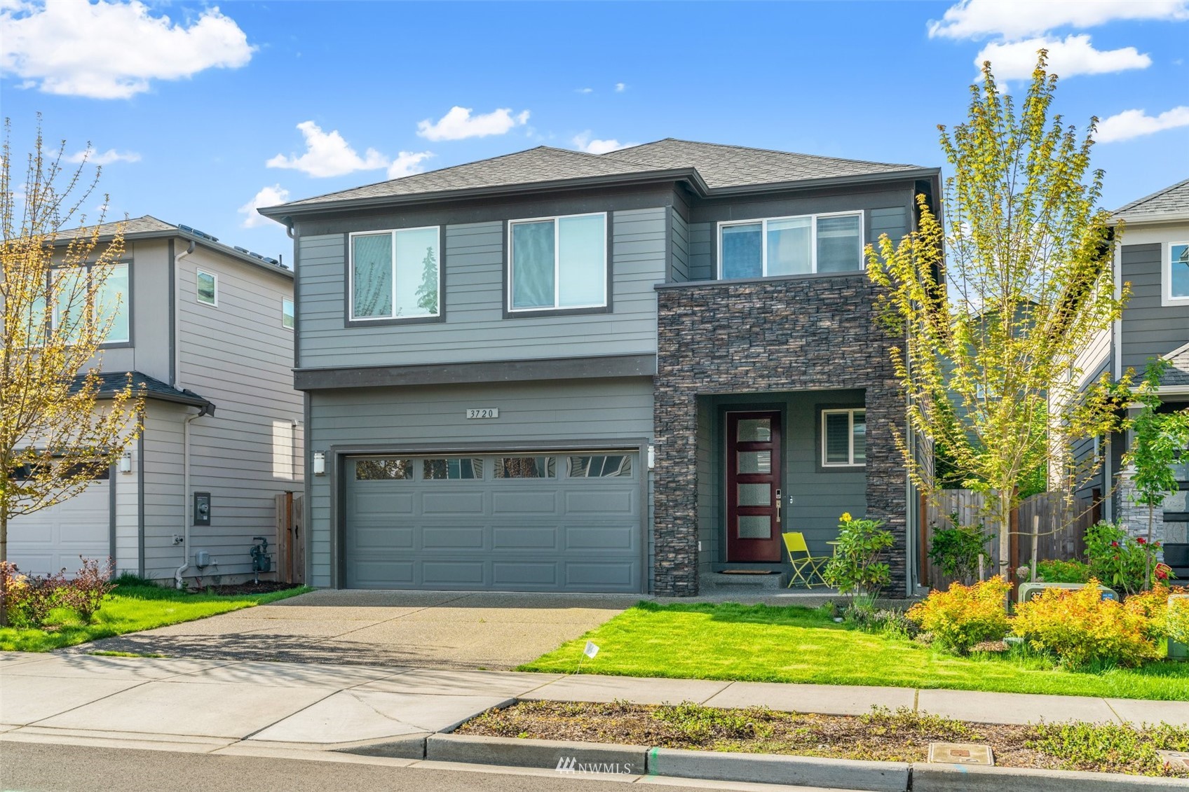 3720 194th Place Southeast Bothell, WA 98012 - Photo 8 of 36 a front view of a house with a garden and trees