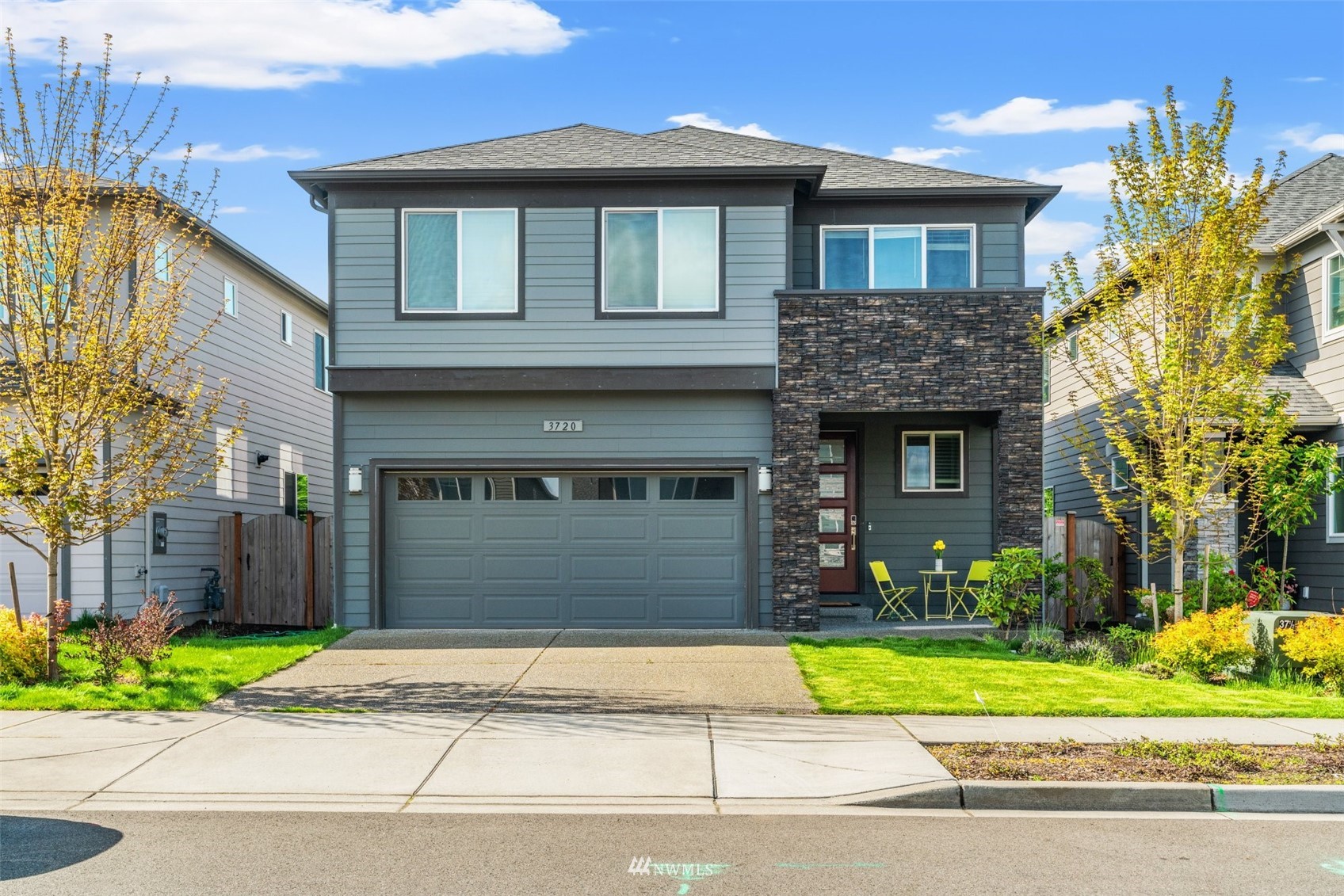 3720 194th Place Southeast Bothell, WA 98012 - Photo 9 of 36 a front view of a house with a yard and garage