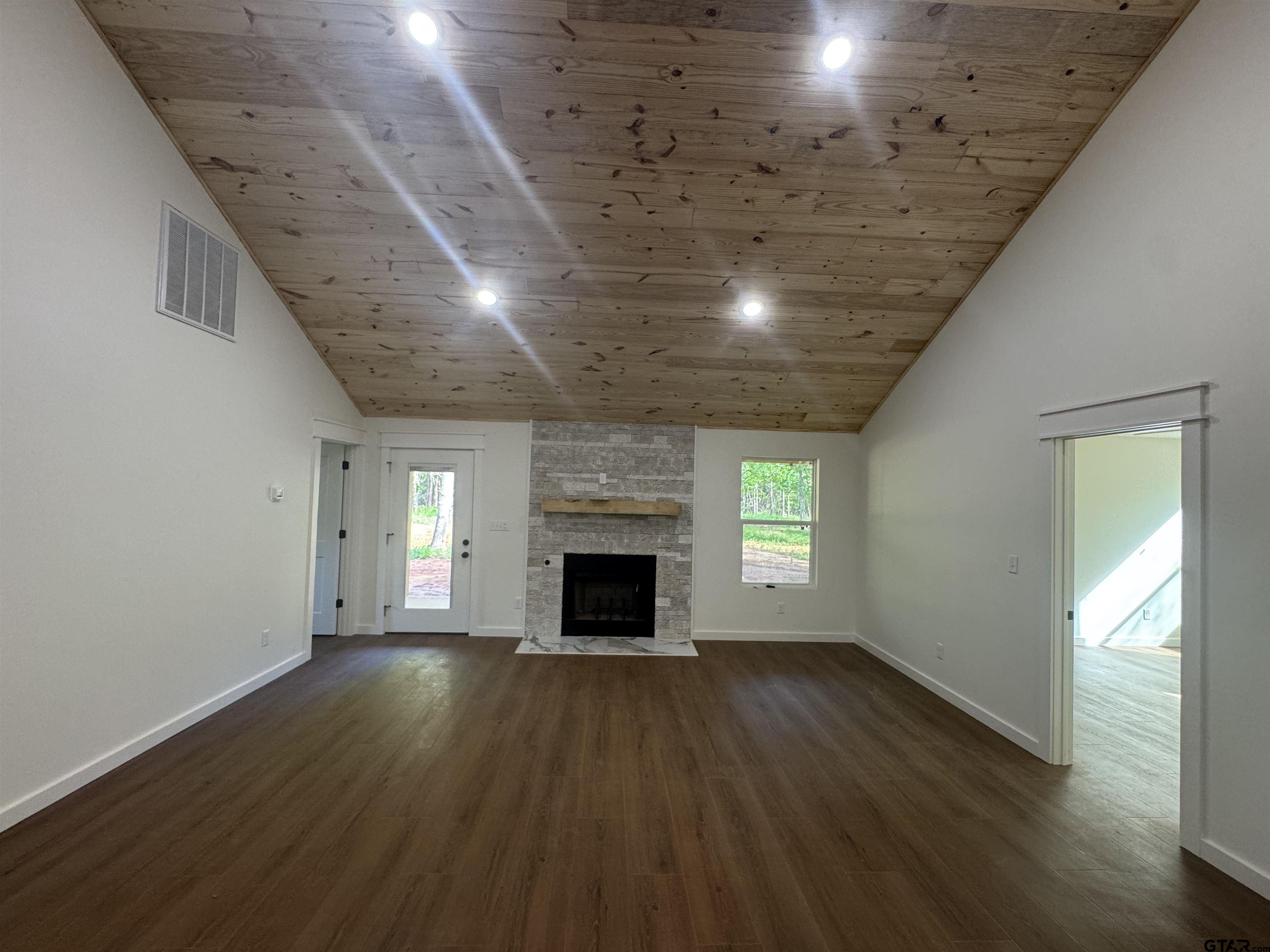 21070-c R 4147 C R 4147 Lindale, TX 75771 - Photo 12 of 23 an empty room with wooden floor fireplace and windows