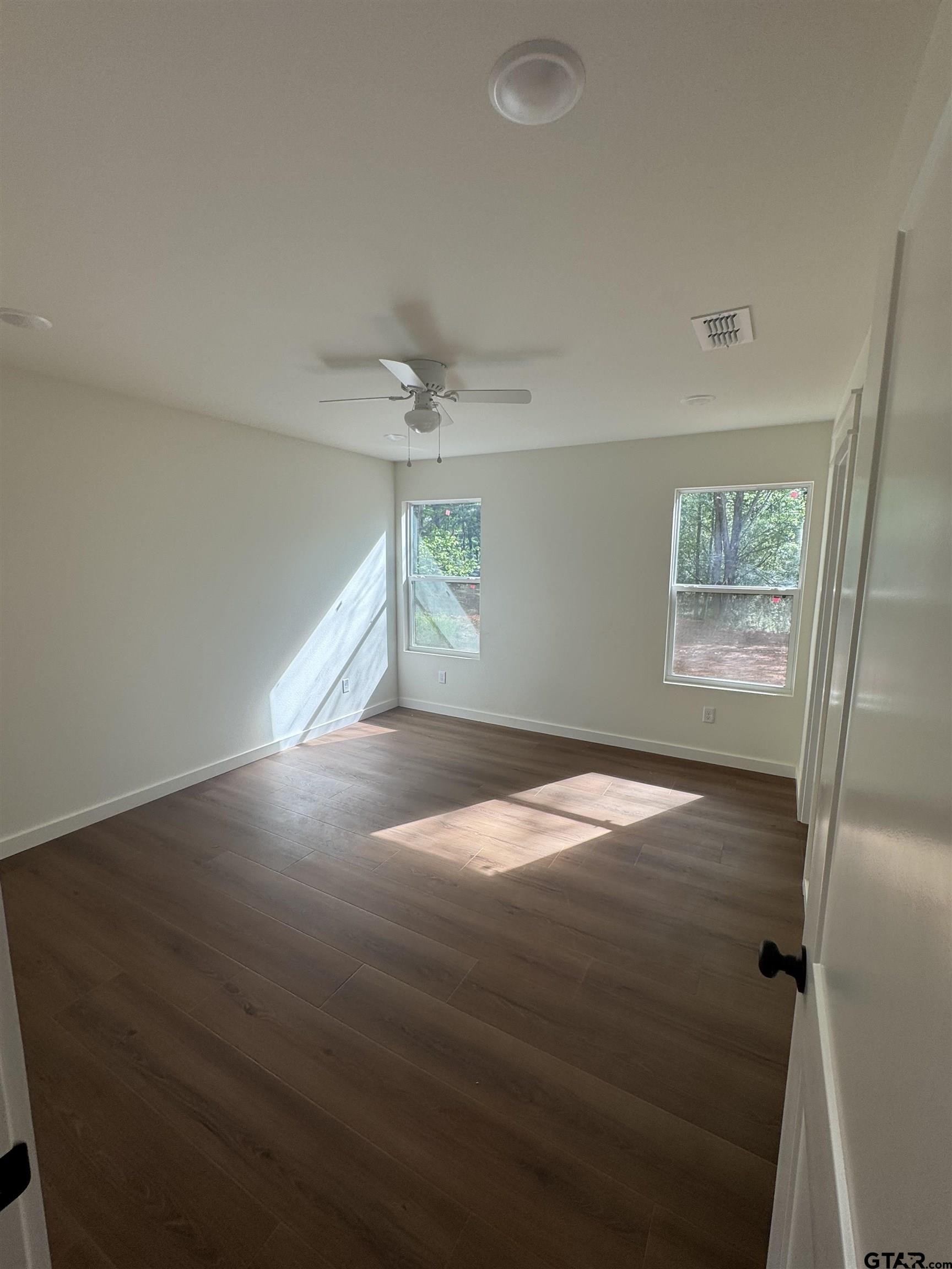 21070-c R 4147 C R 4147 Lindale, TX 75771 - Photo 13 of 23 wooden floor in an empty room with a window