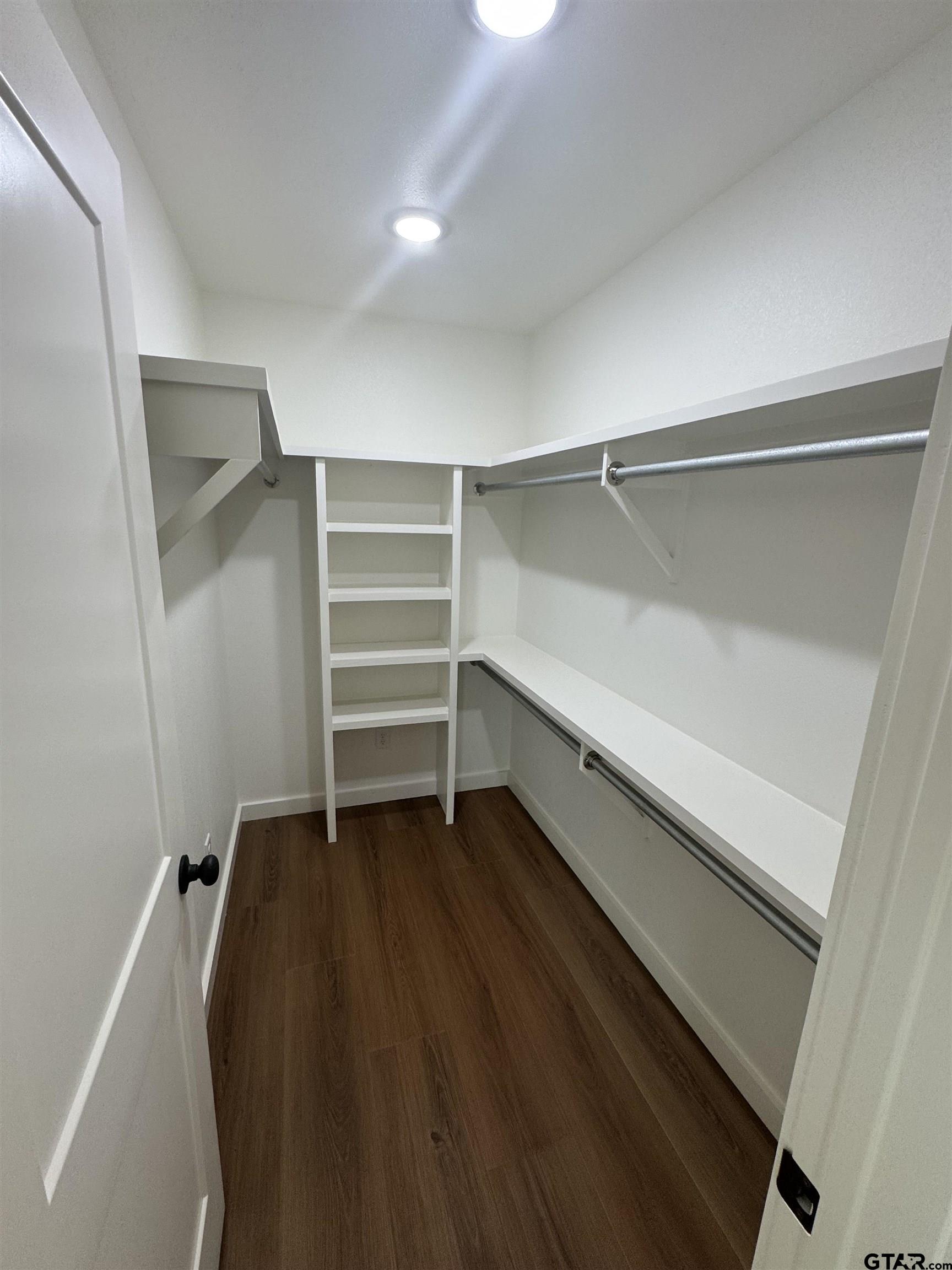 21070-c R 4147 C R 4147 Lindale, TX 75771 - Photo 15 of 23 a view of walk in closet with empty racks