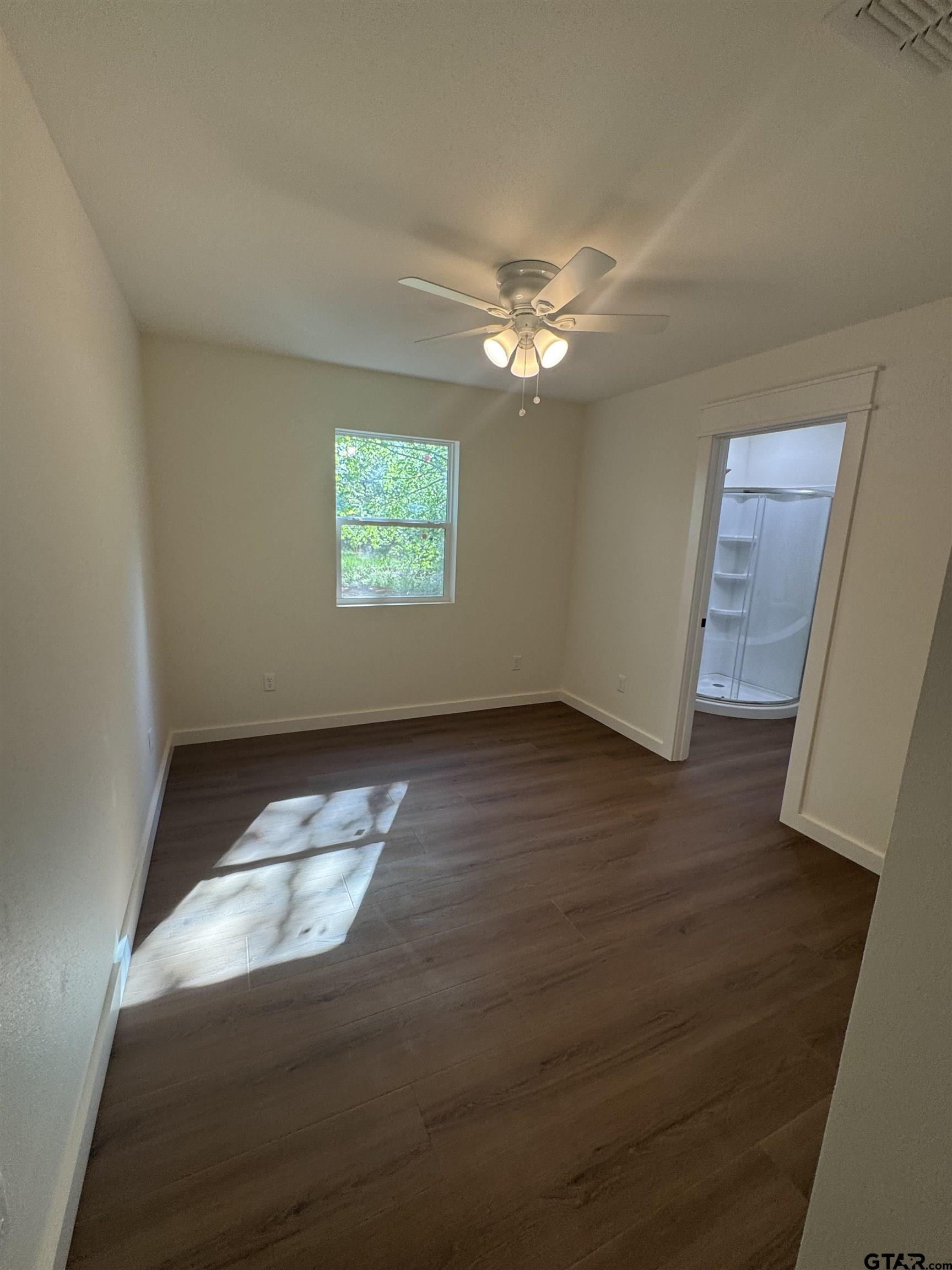 21070-c R 4147 C R 4147 Lindale, TX 75771 - Photo 16 of 23 wooden floor in an empty room with a window
