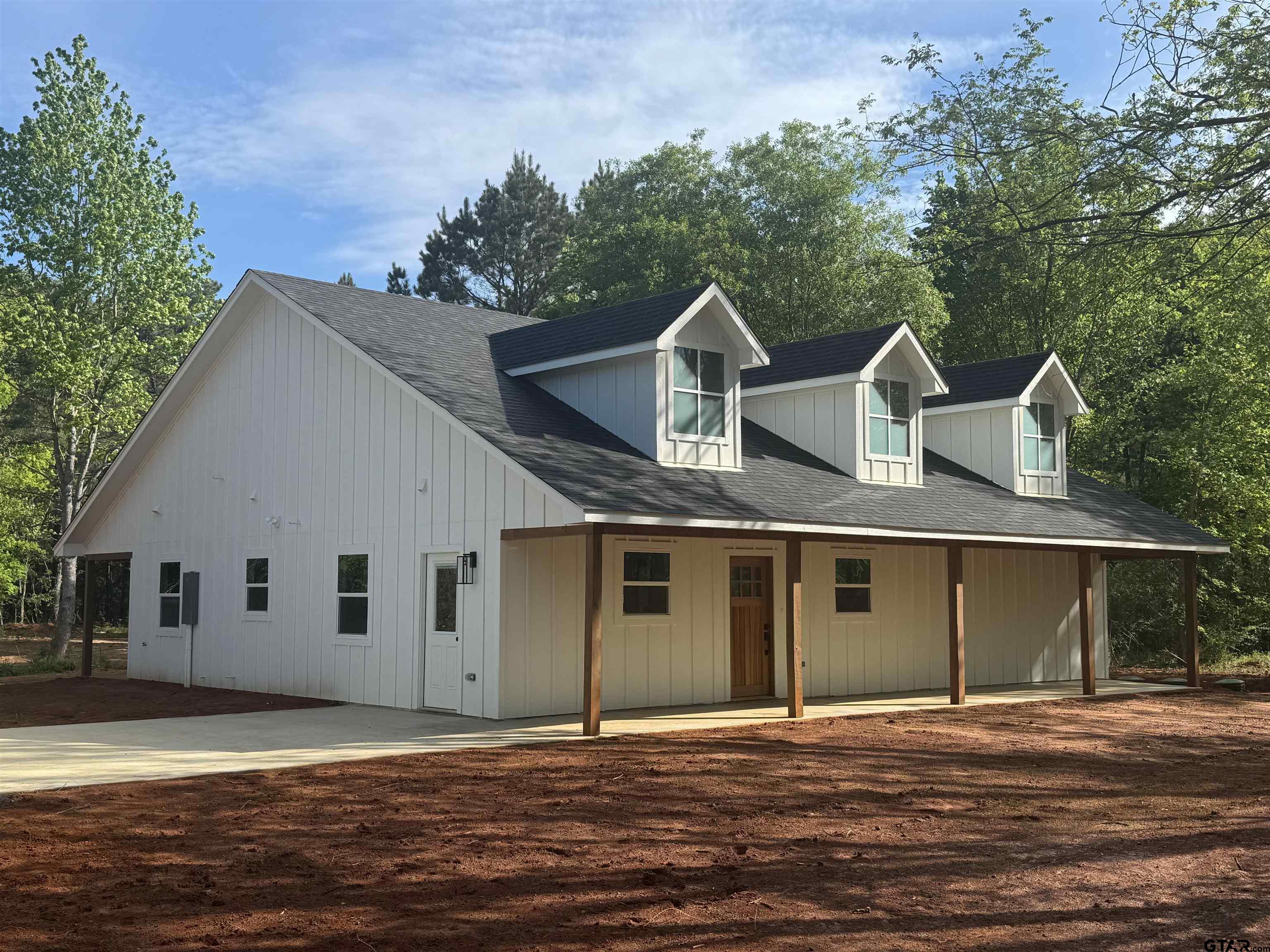 21070-c R 4147 C R 4147 Lindale, TX 75771 - Photo 2 of 23 a front view of a house with a garden