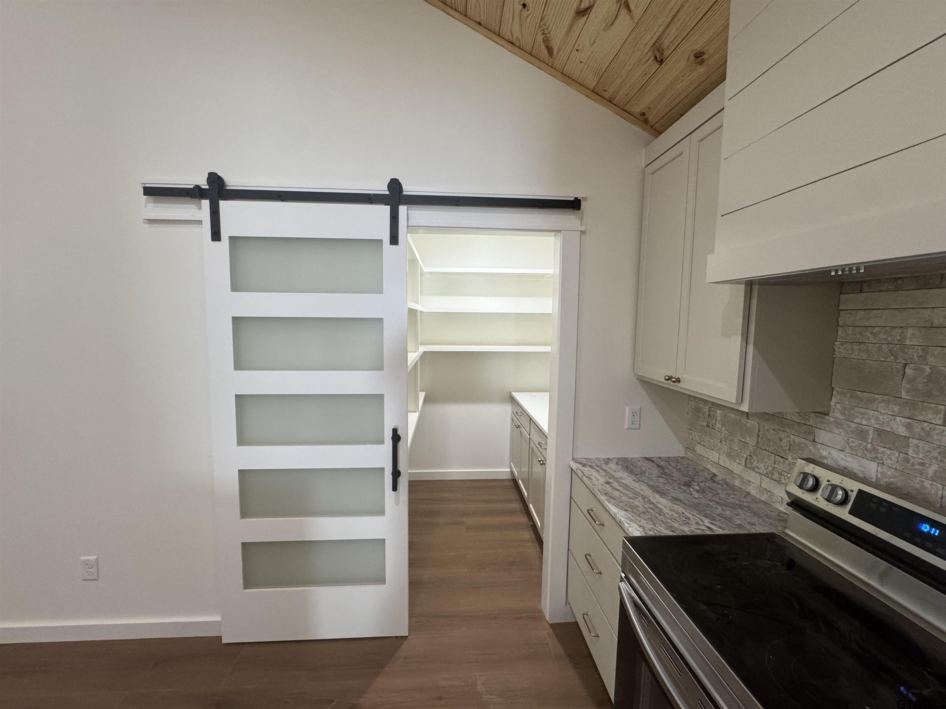 21070-c R 4147 C R 4147 Lindale, TX 75771 - Photo 6 of 23 a kitchen with a wooden floor and a stove top oven