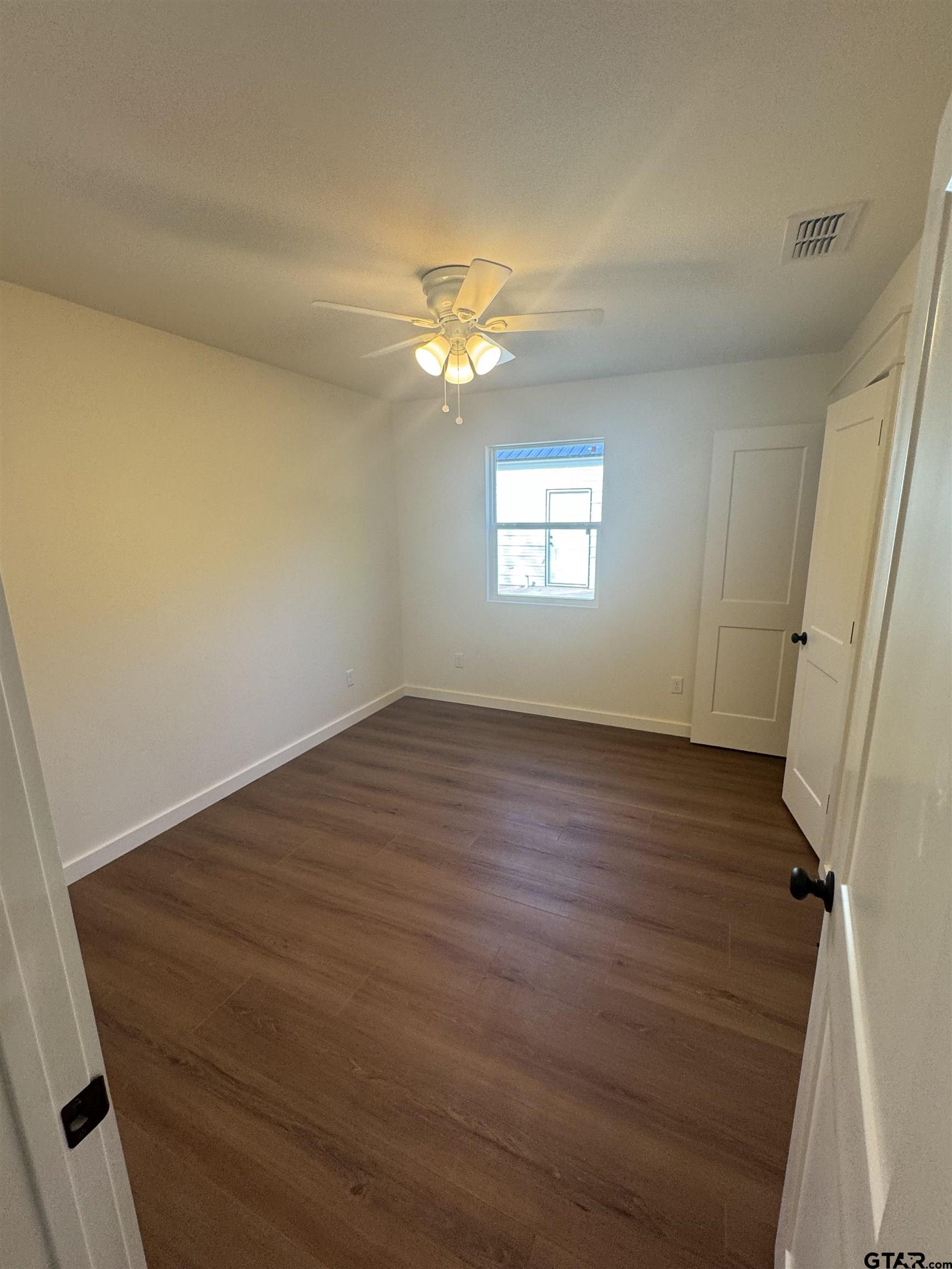 21070-c R 4147 C R 4147 Lindale, TX 75771 - Photo 9 of 23 wooden floor in an empty room with a window