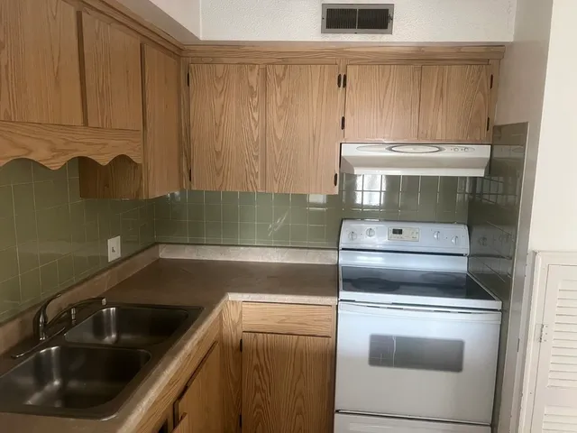 a kitchen with a sink and cabinets