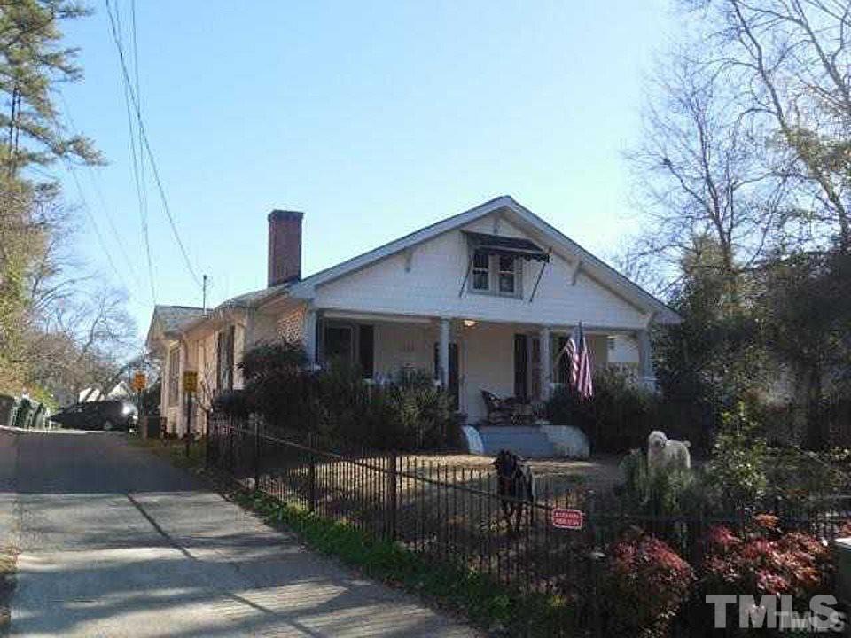 a front view of house with a garden