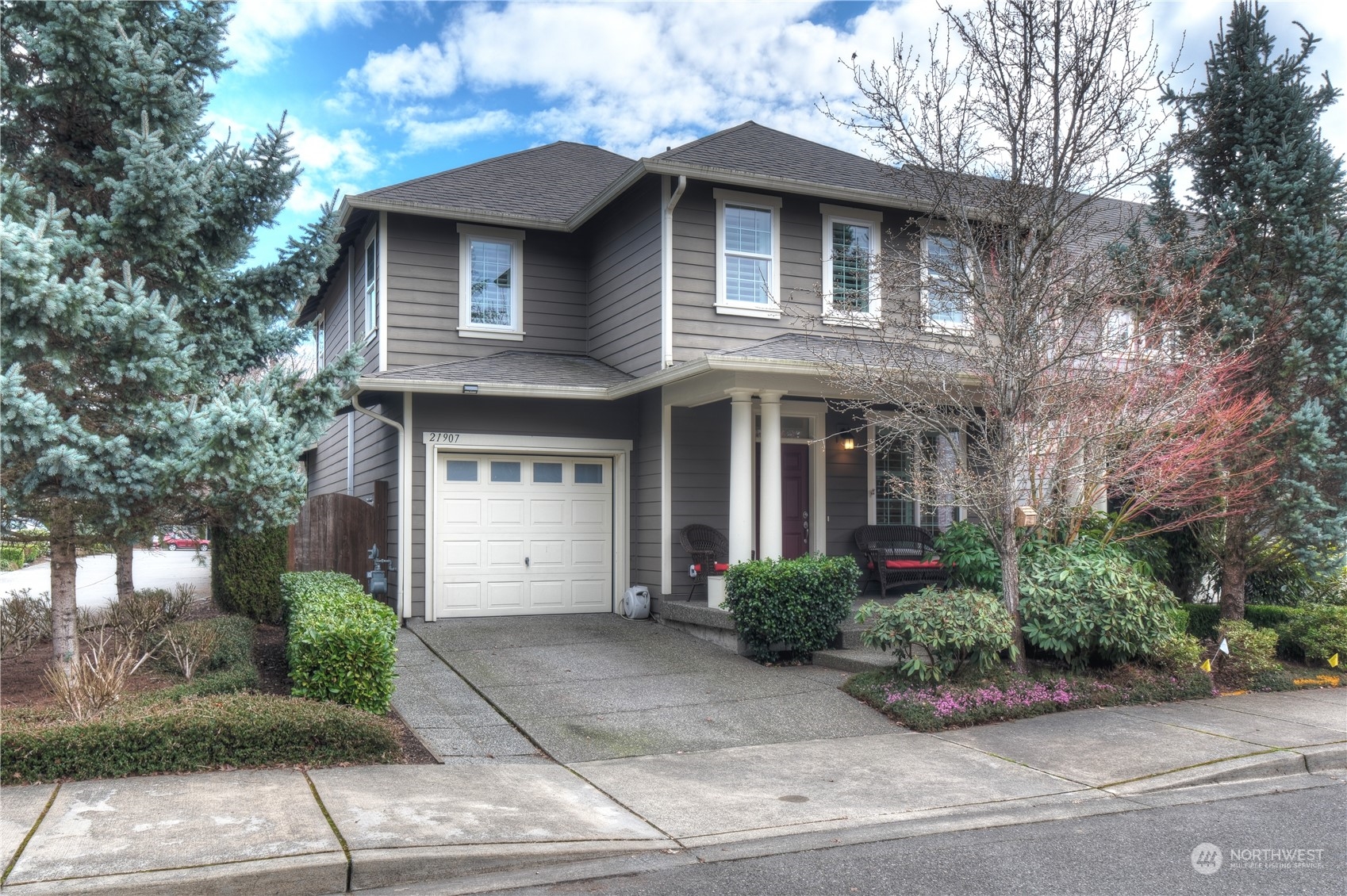 21907 37th Drive Southeast, Unit 30 Bothell, WA 98021 - Photo 1 of 27 a front view of a house with a yard and potted plants