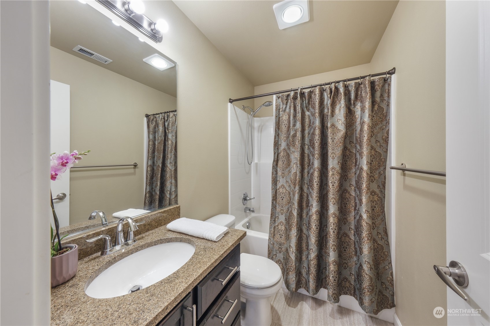 21907 37th Drive Southeast, Unit 30 Bothell, WA 98021 - Photo 19 of 27 a bathroom with a granite countertop sink and a mirror