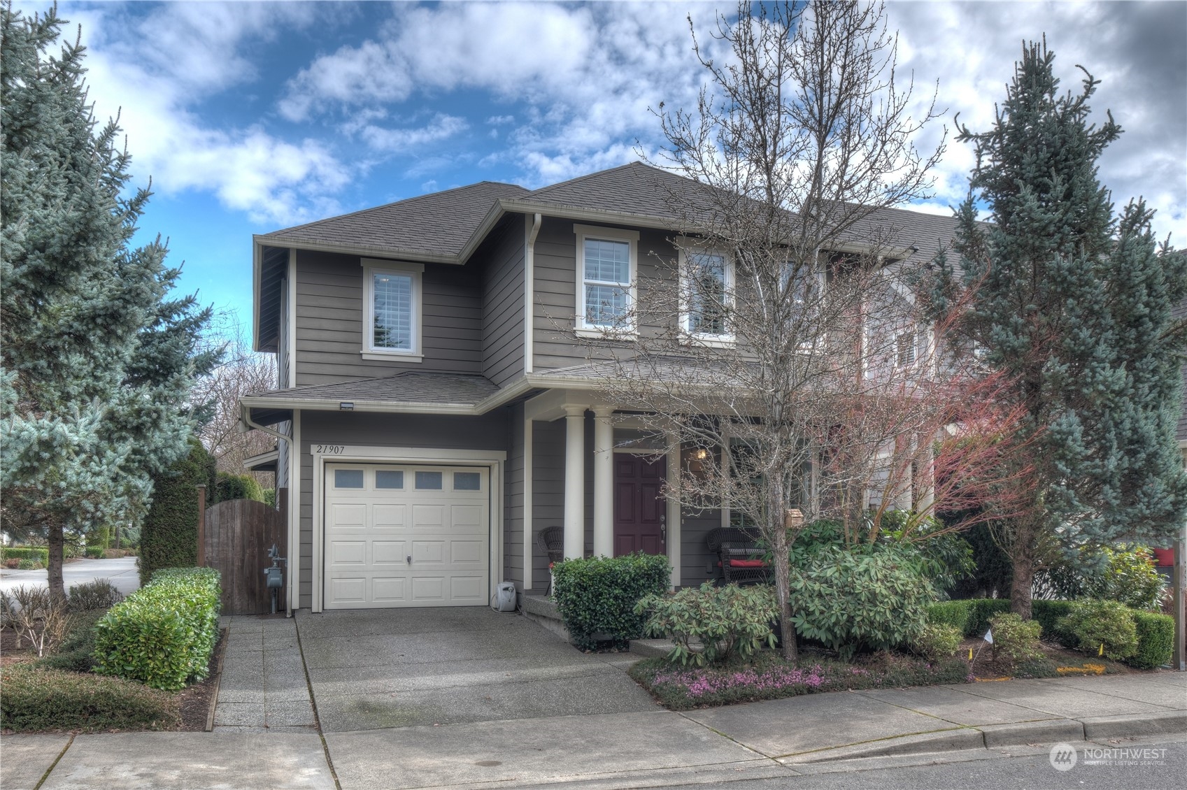 21907 37th Drive Southeast, Unit 30 Bothell, WA 98021 - Photo 26 of 27 a front view of a house with a garden