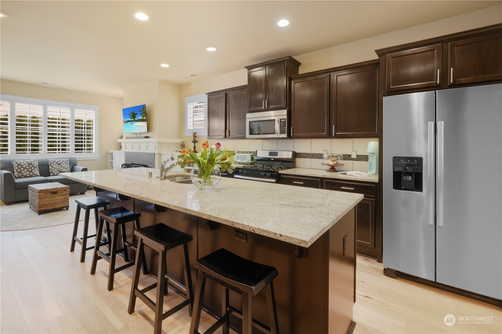 21907 37th Drive Southeast, Unit 30 Bothell, WA 98021 - Photo 6 of 27 a kitchen with a refrigerator a stove a sink and chairs